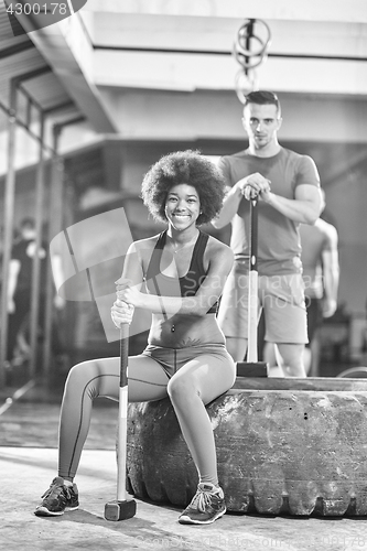 Image of multiethnic couple after workout with hammer