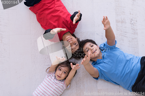 Image of young boys having fun on the floor