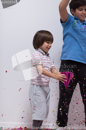 Image of kids  blowing confetti