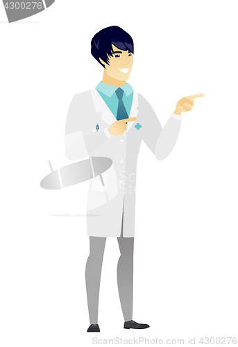 Image of Young asian doctor pointing to the side.