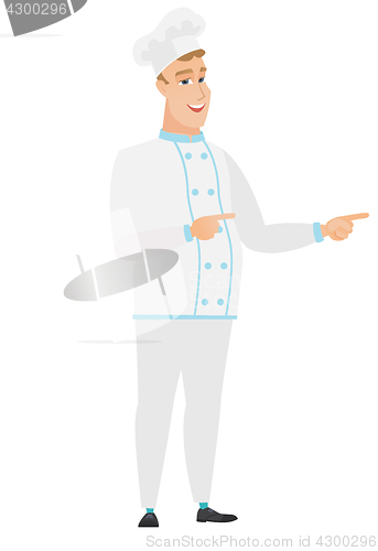 Image of Young caucasian chef cook pointing to the side.