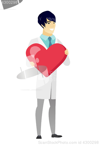 Image of Asian doctor holding a big red heart.