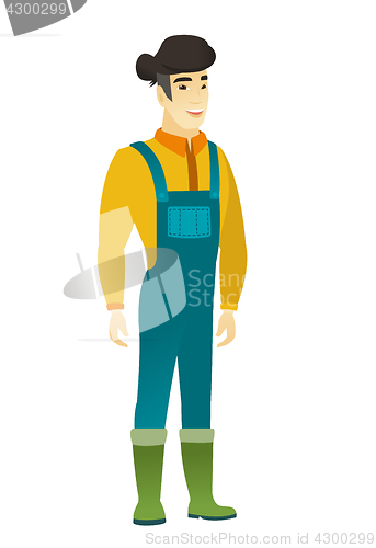 Image of Young asian happy farmer in coveralls.