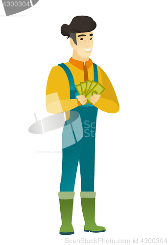 Image of Happy asian farmer holding money.