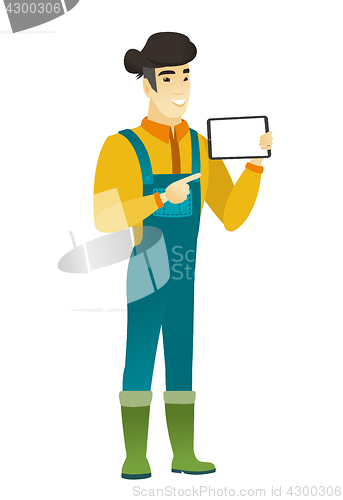 Image of Smiling farmer holding tablet computer.