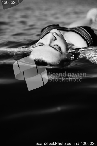 Image of Woman floating on water