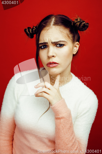 Image of young pretty emitonal posing teenage girl on bright red background, happy smiling lifestyle people concept closeup