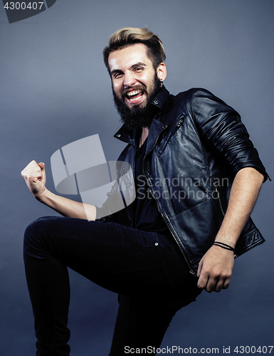 Image of portrait of young bearded hipster guy on gray dark background close up, brutal modern man, lifestyle people concept 