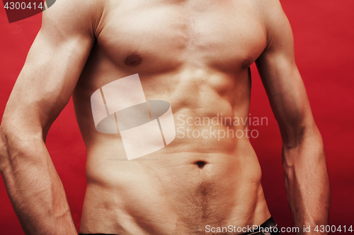 Image of man standing naked torso abc on red background, lifestyle sport people