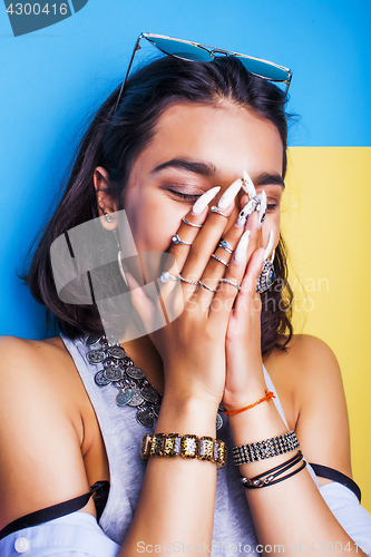 Image of lifestyle people concept. young pretty smiling indian girl with long nails wearing lot of jewelry rings, asian summer happy