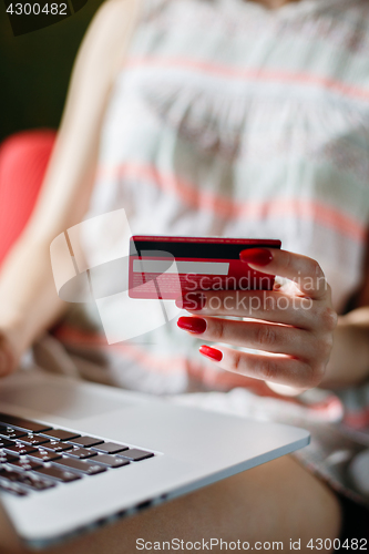 Image of Anonymous woman using card for purchase