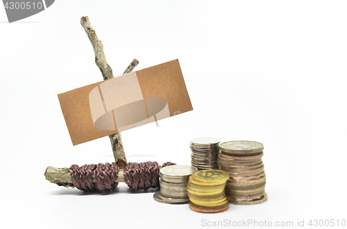 Image of Paper sign board with stack of coins 