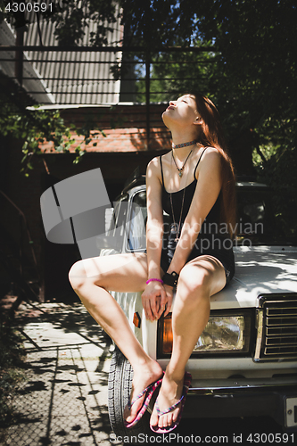 Image of Sensual model posing on car