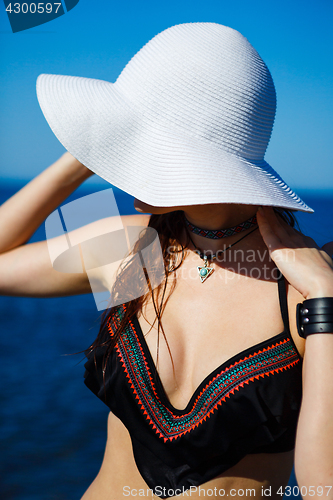 Image of Anonymous model in swimwear and hat