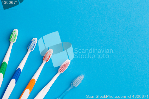 Image of Five toothbrushes, place for words