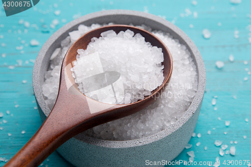 Image of sea salt in stone bowl and wooden spoon