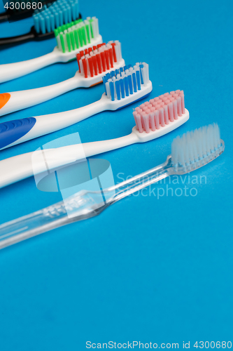 Image of Photo of multi colored toothbrushes