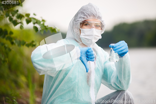 Image of Biologist with bulb ,river bank