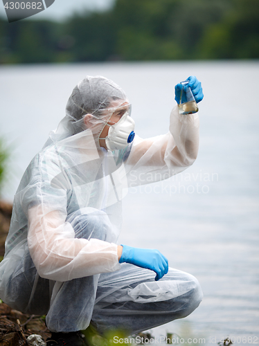 Image of Chemist takes sample of water