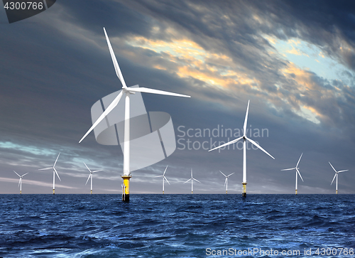 Image of wind turbines under cloud sky