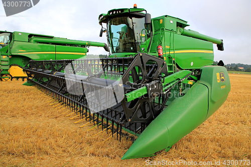 Image of John Deere T660 Combine and 630D Cutter on Stubble Field