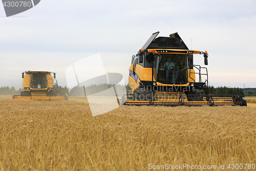 Image of Two Yellow New Holland Combines Harvest Barley