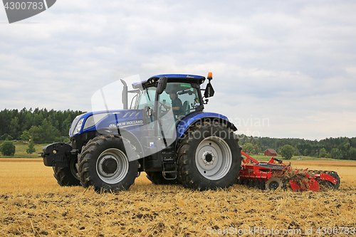 Image of New Holland Tractor and Kverneland Disc Harrow on Stubble Field