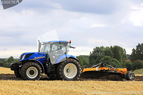 Image of New Holland T7 Tractor and Field Leveller at Work