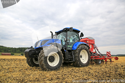 Image of New Holland Tractor and Seed Drill on Field