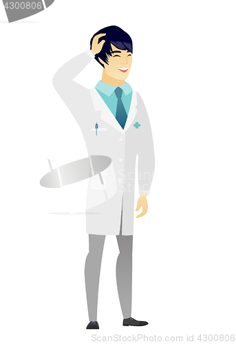 Image of Young asian doctor in medical gown laughing.