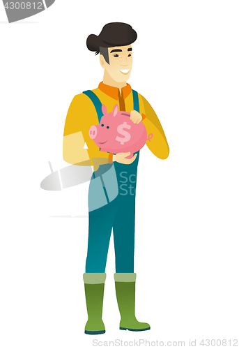 Image of Asian farmer holding a piggy bank.