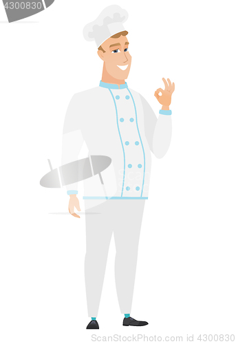 Image of Smiling chef cook showing ok sign.