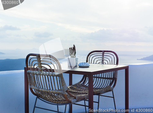 Image of The two chairs and a small table on beautiful terrace with wonderful sea view