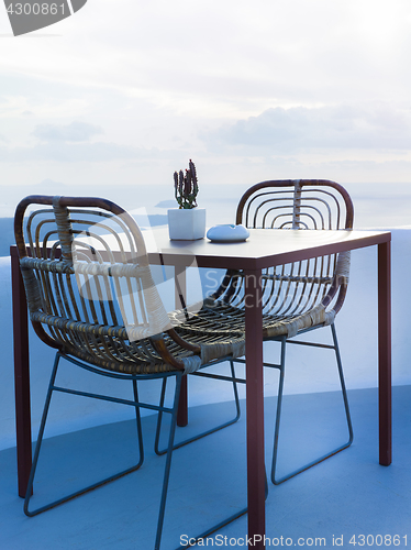 Image of The two chairs and a small table on beautiful terrace with wonderful sea view