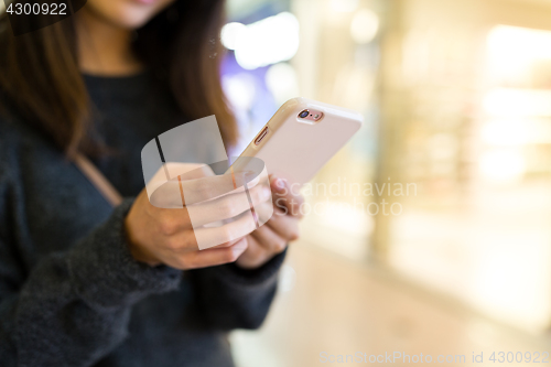 Image of Woman sending text message on cellphone