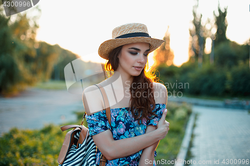 Image of Attractive young woman enjoying her time outside in park