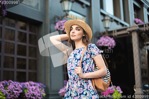 Image of The fashion woman portrait of young pretty trendy girl posing at the city in Europe