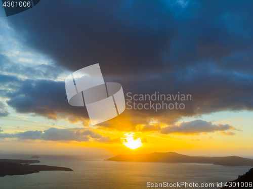 Image of A sunset at Fira town, with view of caldera, volcano