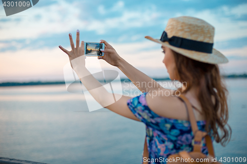 Image of Young woman and river at city