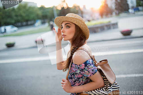 Image of The fashion woman portrait of young pretty trendy girl posing at the city in Europe