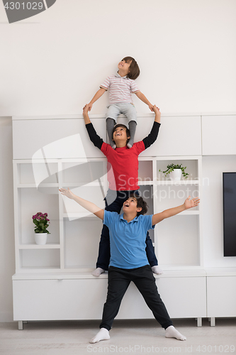 Image of young boys posing line up piggyback