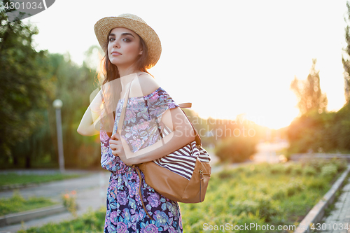 Image of Attractive young woman enjoying her time outside in park