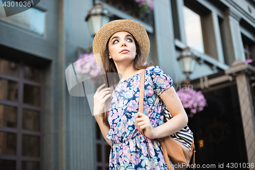 Image of The fashion woman portrait of young pretty trendy girl posing at the city in Europe