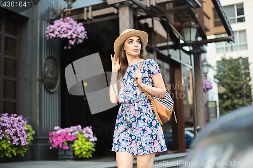 Image of The fashion woman portrait of young pretty trendy girl posing at the city in Europe