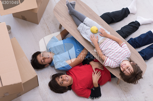 Image of boys with cardboard boxes around them top view