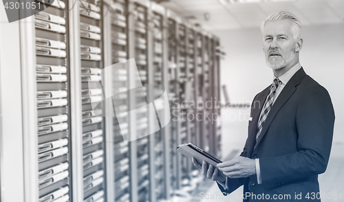 Image of Senior businessman in server room