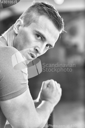 Image of man workout with hammer and tractor tire