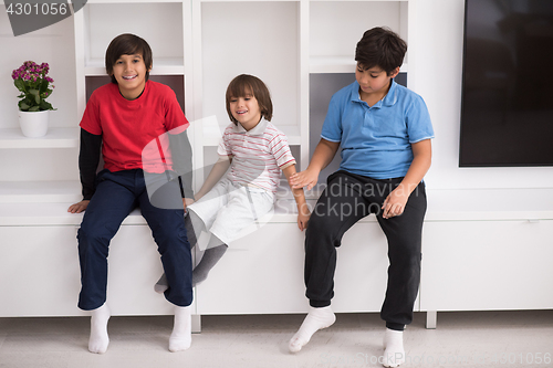 Image of young boys posing on a shelf