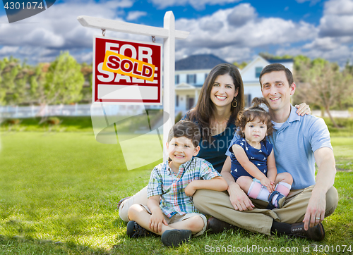 Image of Young Family With Children In Front of Custom Home and Sold For 