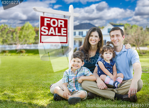 Image of Young Family With Children In Front of Custom Home and For Sale 